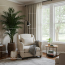 Modern Cozy Living Room with Large Green Palm and Beige Armchair