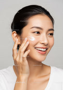 Young Woman Applying Facial Moisturizer for Healthy Skin