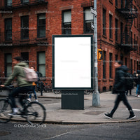 Urban street scene with blank advertising billboard and pedestrians