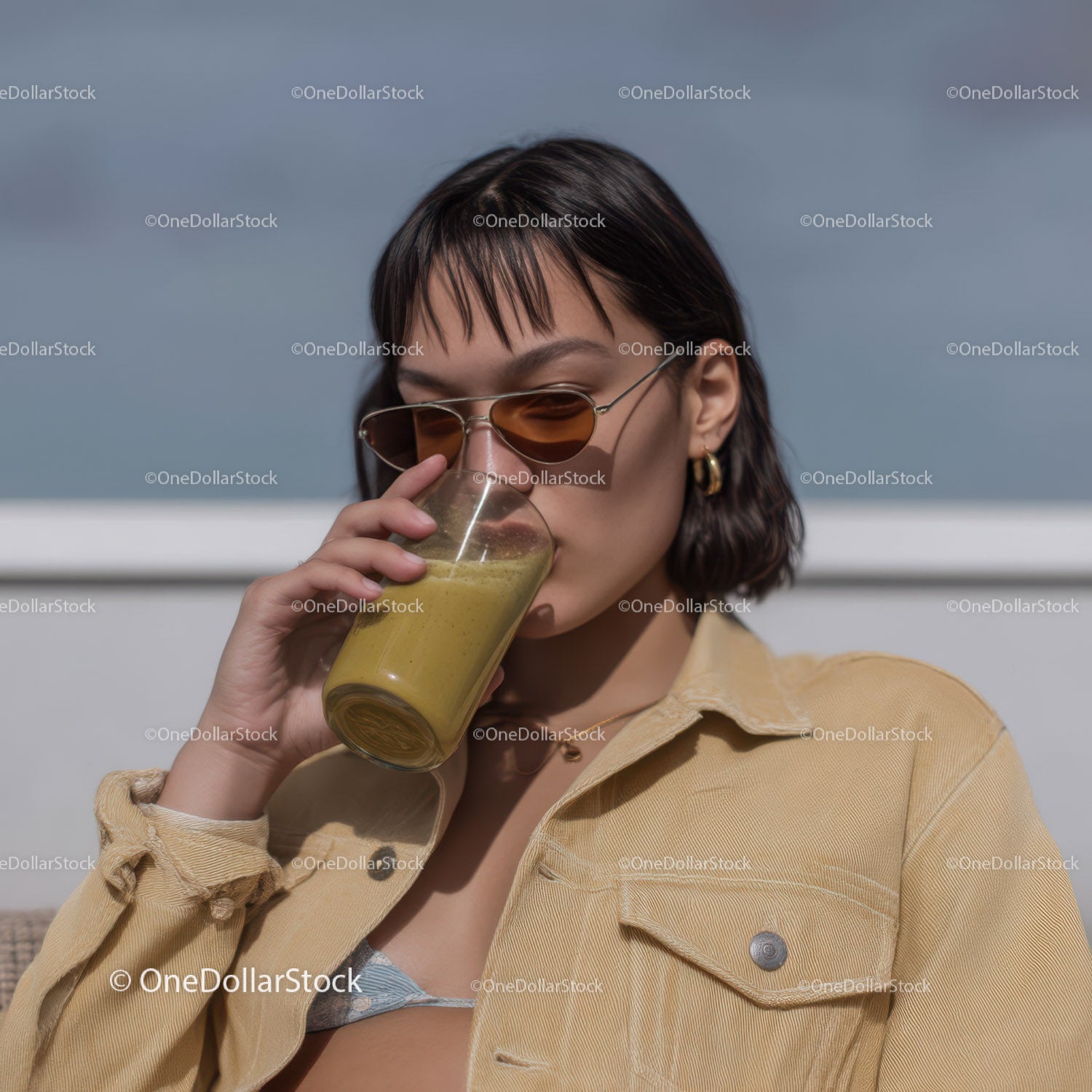 Young Woman Drinking Green Smoothie in Outdoor Summer Scene