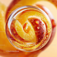 Close-up of Juicy Red and Yellow Apple Slices in a Glass