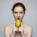 Portrait of a Woman Holding a Pear with Red Hair and Blue Eyes