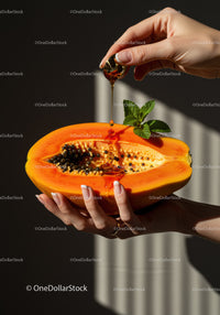 Fresh Papaya with Honey Drizzle and Mint Leaves