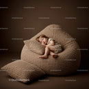 Peaceful toddler sleeping on textured beige bean bag