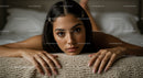 Young Woman with Dark Hair Lying on Bed in Cozy Bedroom Setting
