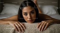 Young Woman with Dark Hair Lying on Bed in Cozy Bedroom Setting