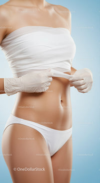 Woman Adjusting White Underwear Showing Toned Flat Belly Skin