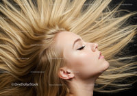 Blonde woman with flowing hair in profile on dark background