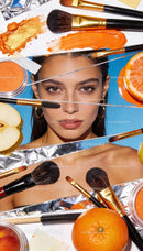 Close-up portrait with orange makeup and fresh fruits