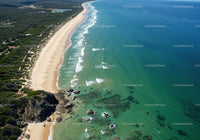 Aerial View of Pristine Sandy Beach with Turquoise Waters and Rocky Coast
