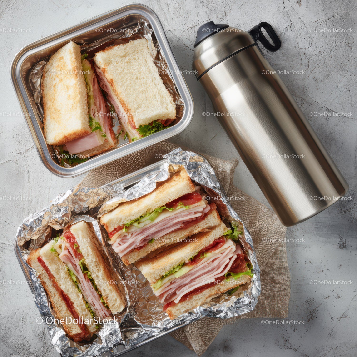 Assorted Deli Sandwiches in Aluminum Foil with Thermos on Light Surface