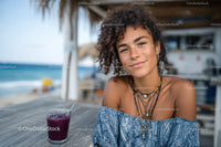 Young Woman Smiling Near Beach with Drinks During Tropical Vacation