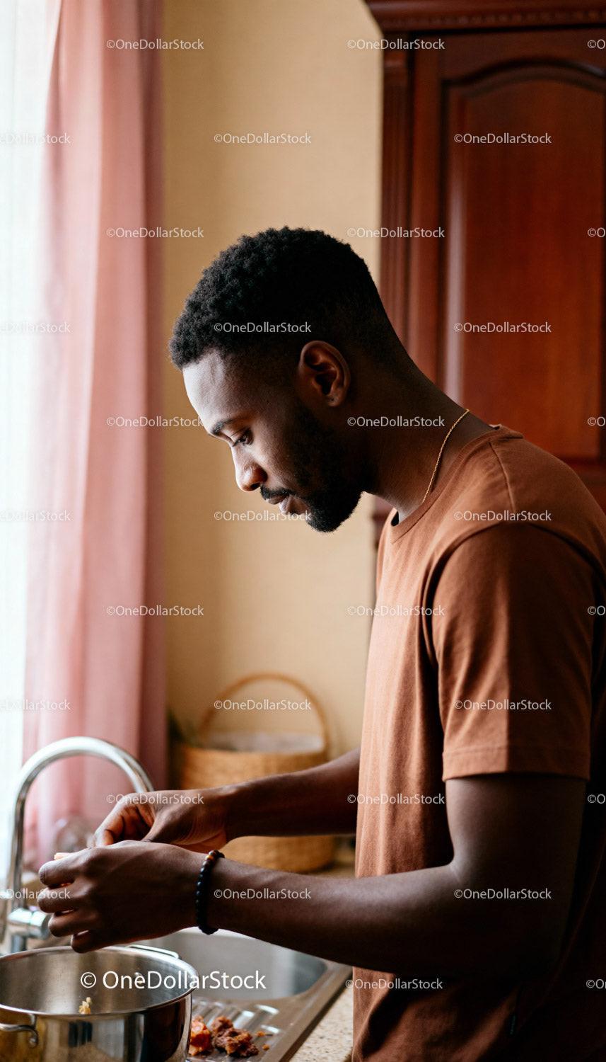 Focused man preparing food by the kitchen sink