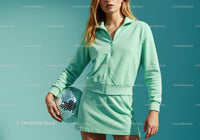 Young Woman in Mint Green Tracksuit Holding Disco Ball in Studio