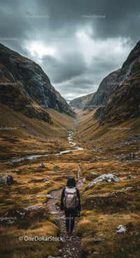 Mountain Valley with Rugged Trails and Dramatic Cloudy Sky