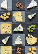 Assorted cheese varieties served on dark slate trays
