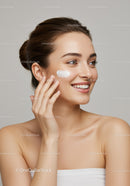 Young Woman Applying Face Cream for Healthy Glowing Skin
