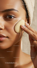 Close-Up of a Woman Applying Foundation with a Sponge on Cheek