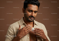 Male Applying Skin Care Cream in Studio Environment