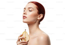 Elegant Woman with Red Hair Holding a Pear for Natural Beauty