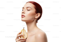 Elegant Woman with Red Hair Holding a Pear for Natural Beauty