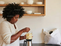 Woman Preparing Fruit Smoothie in Modern Kitchen