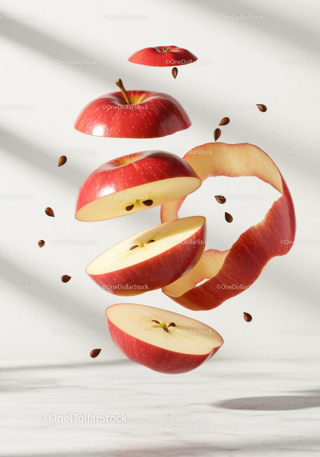 Floating sliced red apple with seeds and peel