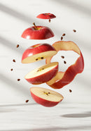 Floating sliced red apple with seeds and peel