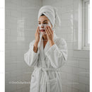 Relaxing Woman Applying Facial Mask in Bathroom