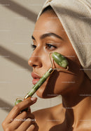 Elegant Woman Using Jade Roller for Relaxing Facial Skincare Treatment