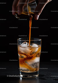 Cold Drink with Coffee Pouring over Ice Cubes