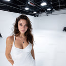 Beautiful Young Woman in Casual White Dress in Studio Setting