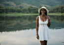 Young Woman in White Dress and Hat by Lake in Summer Scene