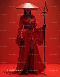 Elegant Woman in Red Dress with Accessories Against Red Background