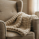 Cozy armchair with chunky knit beige blanket