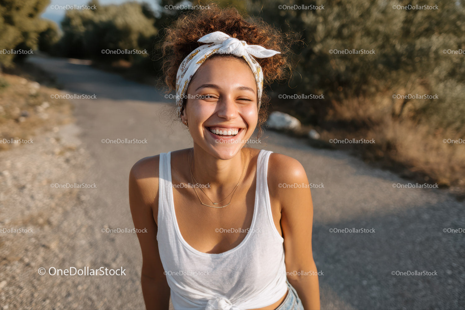 Joyful Woman With Curly Hair and Headband Smiling Outdoors
