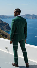 Man in Green Suit Overlooking Scenic Coastal Cliffs
