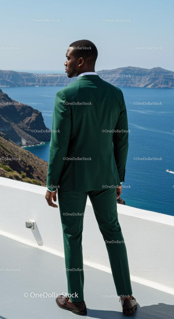 Man in Green Suit Overlooking Scenic Coastal Cliffs