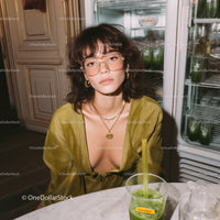 Stylish Woman in Yellow Silk Blouse Sitting at Modern Kitchen Table