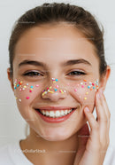 Joyful Young Woman Smiling with Colorful Sprinkles on Face