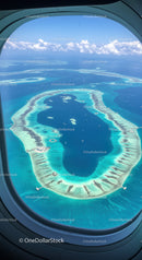 Aerial View of a Tropical Island with Blue Water and Coral Reef