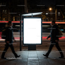 Illuminated bus stop advertising panel at night city street