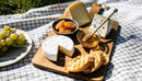 Cheese Platter with Honey, Apricots and Grapes Outdoors