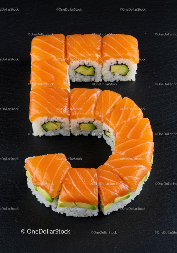 Sushi Rolls Arranged in Number Five on Black Surface