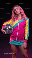 Stylish Woman with Pink Hair Holding Disco Ball in Colorful Tracksuit