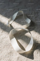 Close-up of White Plastic Ribbon Waste on Sandy Beach