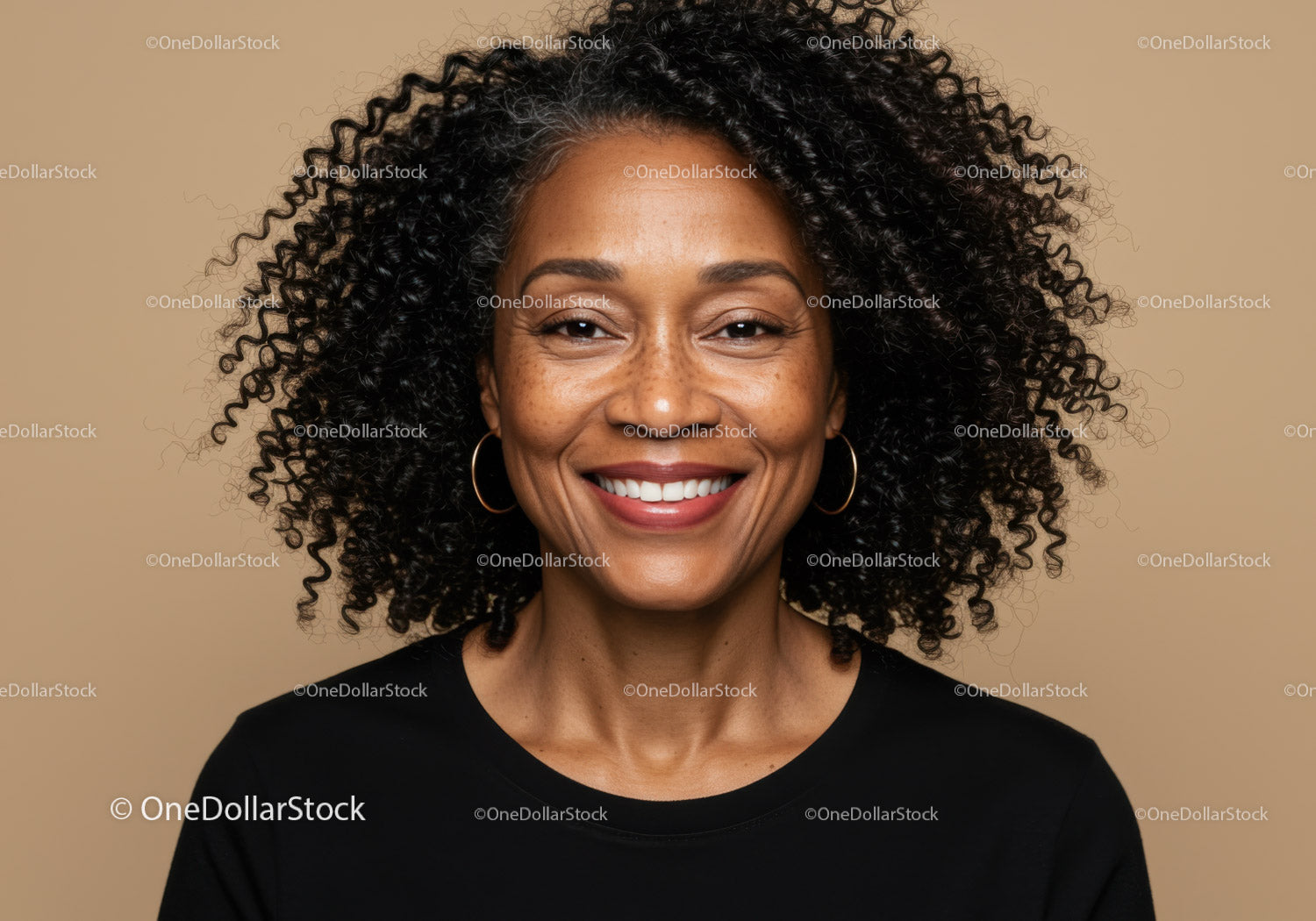 Confident Woman with Curly Hair and Warm Smile in Studio