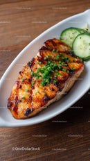 Grilled Salmon with Cucumber Slices and Green Onions on White Plate