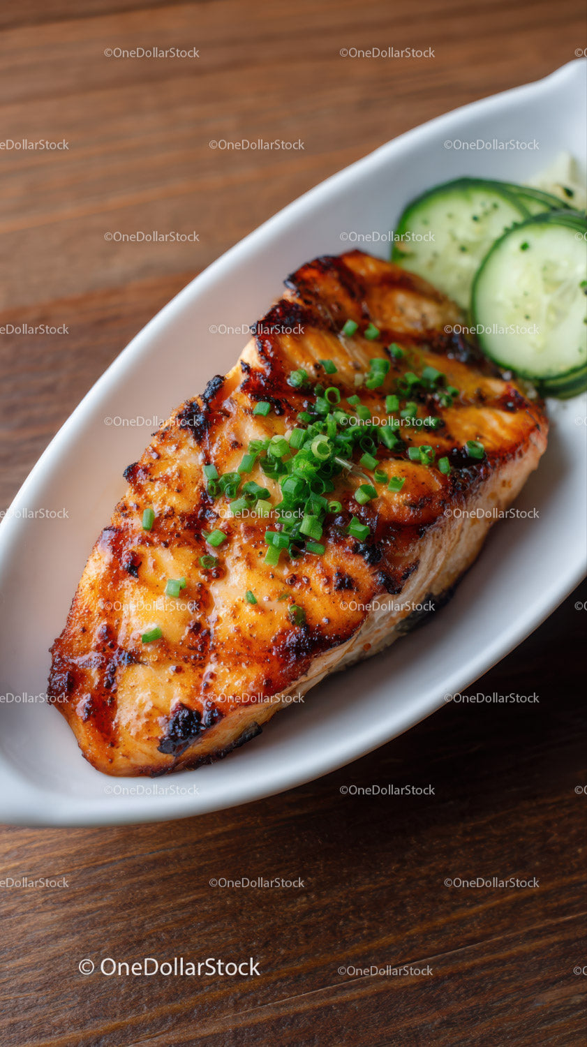 Grilled Salmon with Cucumber Slices and Green Onions on White Plate