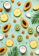 Tropical fruits arranged on pastel green background